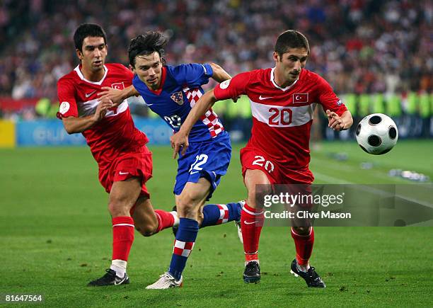 Sabri Sarioglu of Turkey is challenged by Danijel Pranjic of Croatia as Arda Turan of Turkey looks on during the UEFA EURO 2008 Quarter Final match...