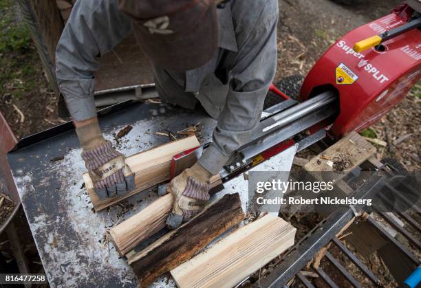 Robert Marble splits firewood June 29, 2017 on his converted dairy farm in Charlotte, Vermont. Marble is a firewood supplier who has cut and sold...