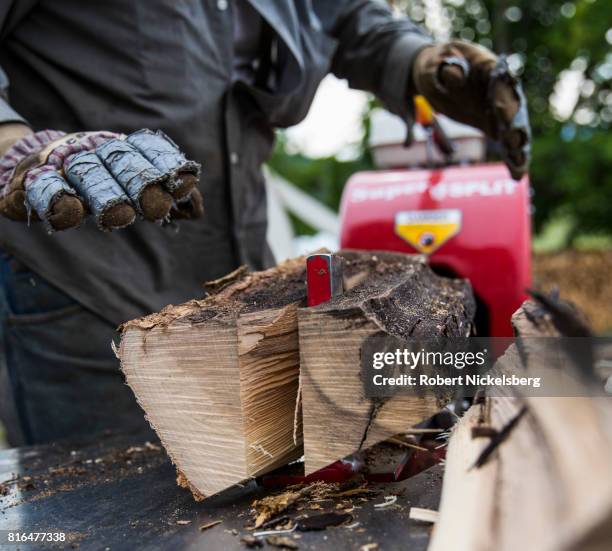 Robert Marble splits firewood June 29, 2017 on his converted dairy farm in Charlotte, Vermont. Marble is a firewood supplier who has cut and sold...