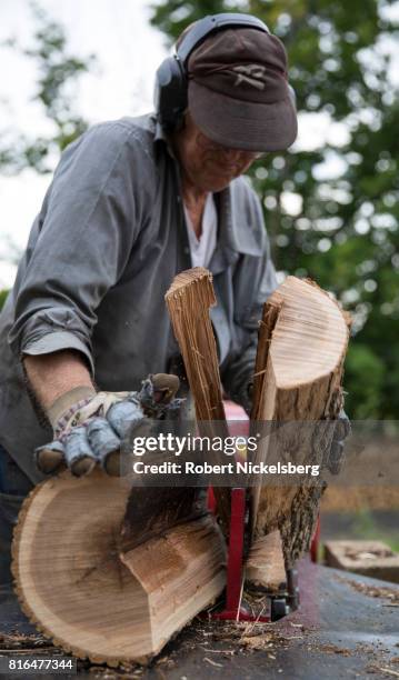 Robert Marble splits firewood June 29, 2017 on his converted dairy farm in Charlotte, Vermont. Marble is a firewood supplier who has cut and sold...