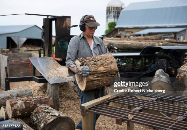 Robert Marble splits firewood June 29, 2017 on his converted dairy farm in Charlotte, Vermont. Marble is a firewood supplier who has cut and sold...