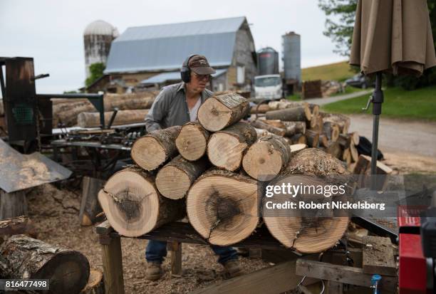 Robert Marble splits firewood June 29, 2017 on his converted dairy farm in Charlotte, Vermont. Marble is a firewood supplier who has cut and sold...