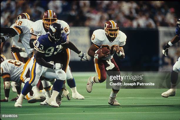 Running back Brian Mitchell of the Washington Redskins runs upfield against the Minnesota Vikings in the 1992 NFC Wildcard Game at the Metrodome on...