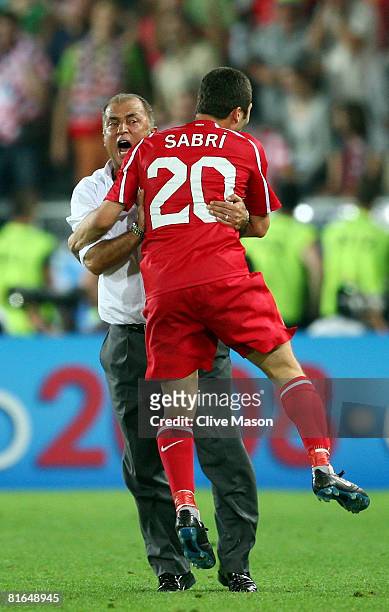 Fatih Terim head coach of Turkey and Sabri Sarioglu celebrate after Semih Senturk scores in the last minute of extra time during the UEFA EURO 2008...