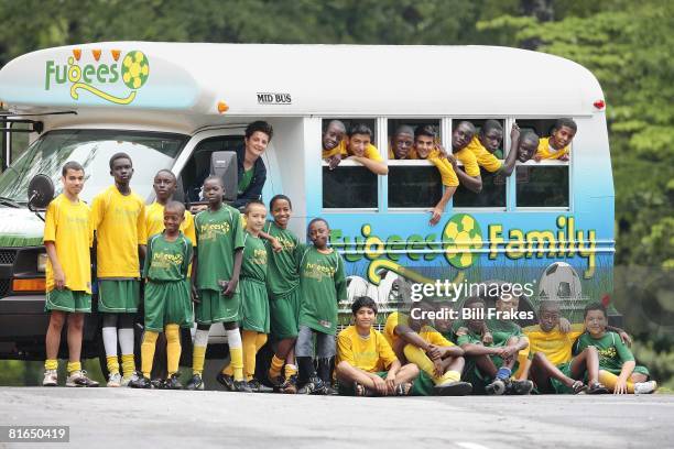 Refugee Program: Portrait of Fugees Family team with donated bus. Top Row Coach Luma Mufleh, Prince Tarlue, Shahir Anwar, Josiah Saydee, Mohammed...