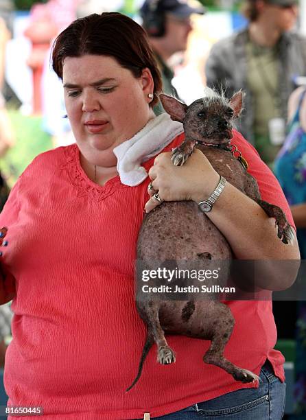 Heather Peoples of Phoenix, Arizona holds her Chinese Crested dog named Archie before the start of the 20th Annual Ugliest Dog Competition at the...