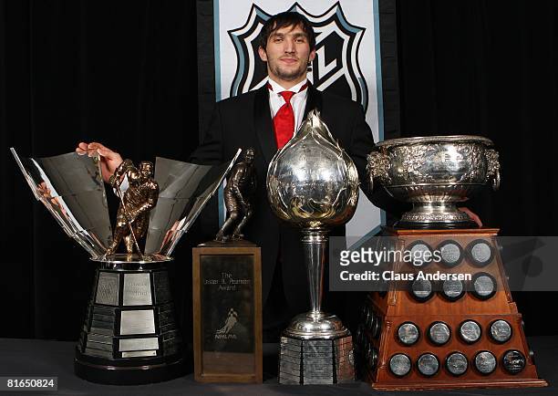 Alexander Ovechkin of the Washington Capitals poses with the Hart Memorial Trophy, the Lester B. Pearson Award, the Art Ross Trophy, and the Maurice...