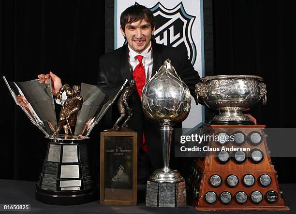 Alexander Ovechkin of the Washington Capitals poses with the Hart Memorial Trophy, the Lester B. Pearson Award, the Art Ross Trophy, and the Maurice...