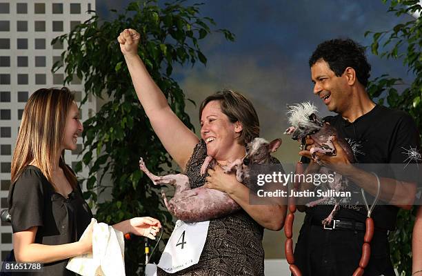 Jeanenne Teed of St. Petersburg, Florida celebrates with her one-eyed, three legged Chinese Crested dog named Gus, her daughter Janey Teed and Dane...