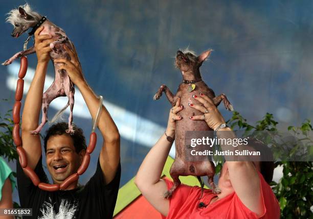 Dane Andrew and Heather Peoples hold up their dogs Rascal and Archie during the 20th Annual World's Ugliest Dog Competition at the Sonoma-Marin Fair...