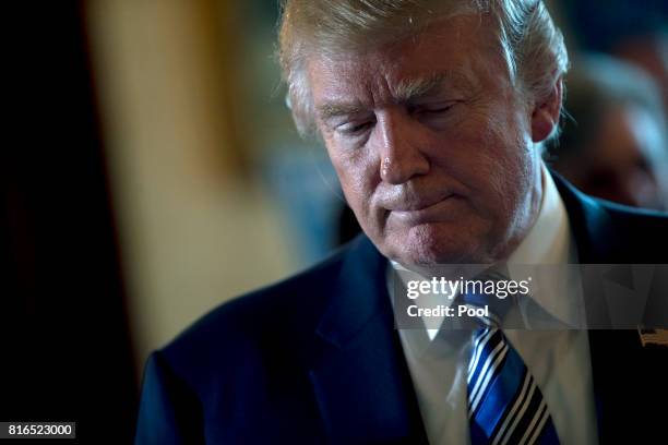 President Donald Trump pauses while participating in a Made in America event with companies from 50 states featuring their products in the Blue Room...