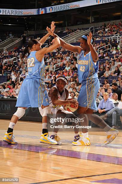 Cappie Pondexter of the Phoenix Mercury looks to pass against Armintie Price and Tye'sha Fluker of the Chicago Sky on June 20 at U.S. Airways Center...
