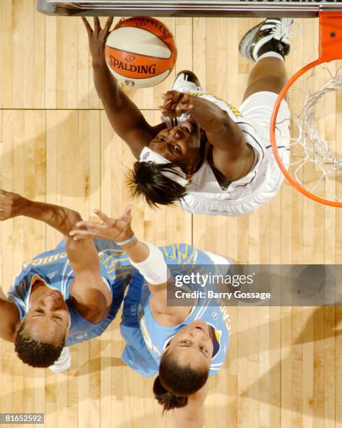 Barbara Farris of the Phoenix Mercury shoots against Chasity Melvin and Candice Dupree of the Chicago Sky on June 20 at U.S. Airways Center in...