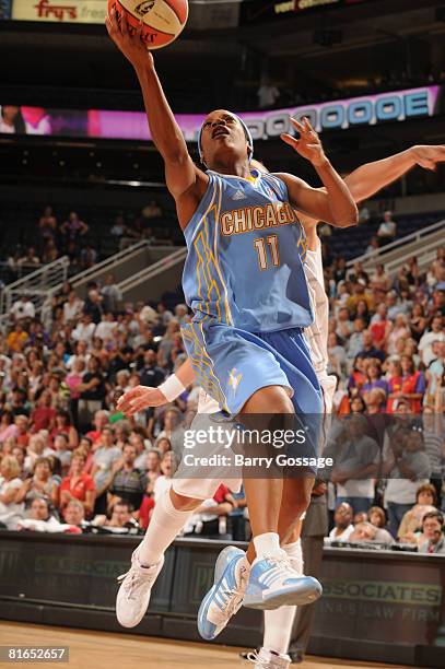 Jia Perkins of the Chicago Sky shoots against Diana Taurasi of the Phoenix Mercury on June 20 at U.S. Airways Center in Phoenix, Arizona. NOTE TO...