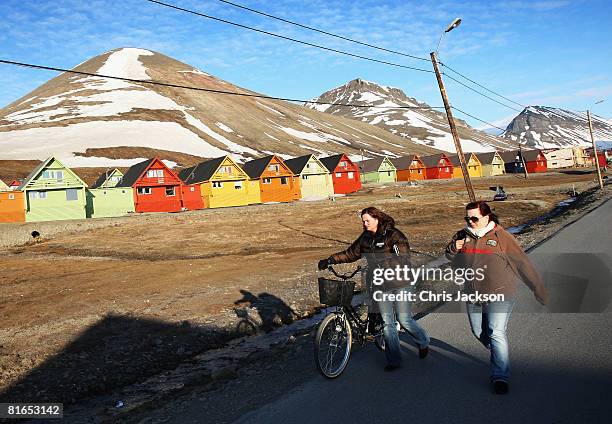 People walk past colourful cabins in the early morning of Midsummer on June 21, 2008 in Longyearbyen, Norway. Longyearbyen is the seat of Norwegian...