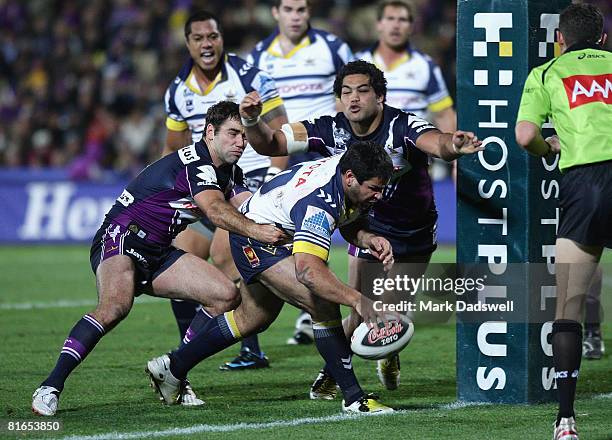 Carl Webb of the Cowboys puts the ball down to score a try during the round 15 NRL match between the Melbourne Storm and the North Queensland Cowboys...