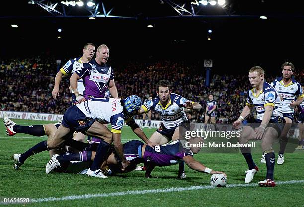 Israel Folau of the Storm puts the ball down over the try line during the round 15 NRL match between the Melbourne Storm and the North Queensland...