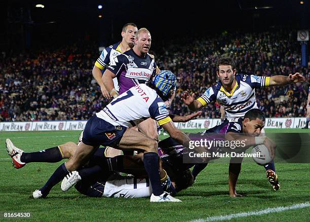 Israel Folau of the Storm reaches for the try line during the round 15 NRL match between the Melbourne Storm and the North Queensland Cowboys at...