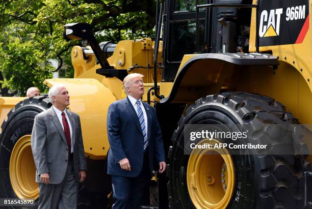 President Donald Trump and Vice President Mike Pence examine an iconic Yellow Iron from Caterpillar Inc. During a "Made in America" product showcase...