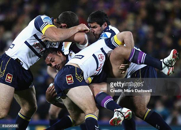 Jeff Lima of the Storm is tackled during the round 15 NRL match between the Melbourne Storm and the North Queensland Cowboys at Olympic Park on June...