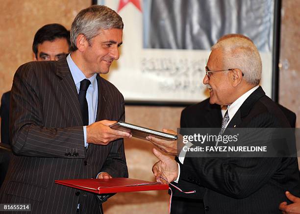 Algerian Defense Minister Abdelmalek Guenaizia and his French counterpart Herve Morin exchange documents during the signing of a military agreement...