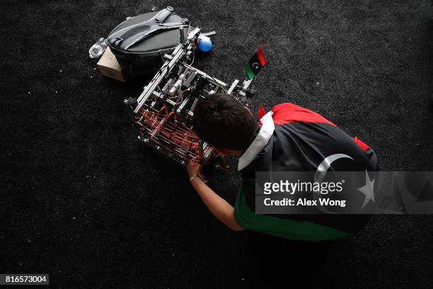 Member of Team Libya works on his team's robot during the first of two days of the First Global International Robot Olympics, an international...