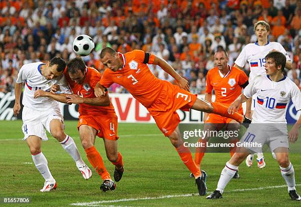 Sergei Semak of Russia and John Heitinga and Joris Mathijsen of Netherlands battle for the header during the UEFA EURO 2008 Quarter Final match...