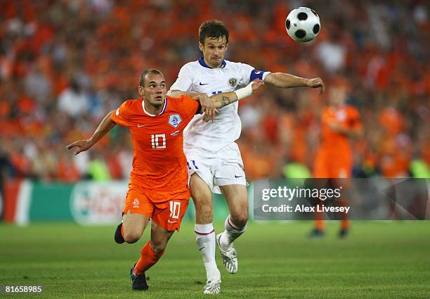 Sergei Semak of Russia chases for the ball with Wesley Sneijder of Netherlands during the UEFA EURO 2008 Quarter Final match between Netherlands and...