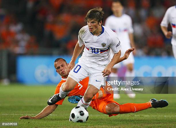 Andrei Arshavin of Russia takes the ball past John Heitinga of Netherlands during the UEFA EURO 2008 Quarter Final match between Netherlands and...