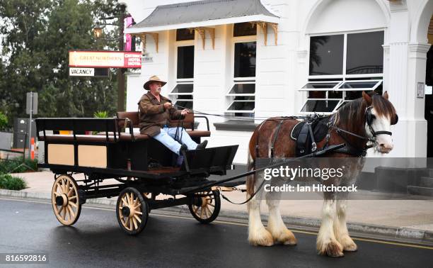 Seen is a man riding in a horse drawn carriage along the streets on July 09, 2017 in Rockhampton, Australia