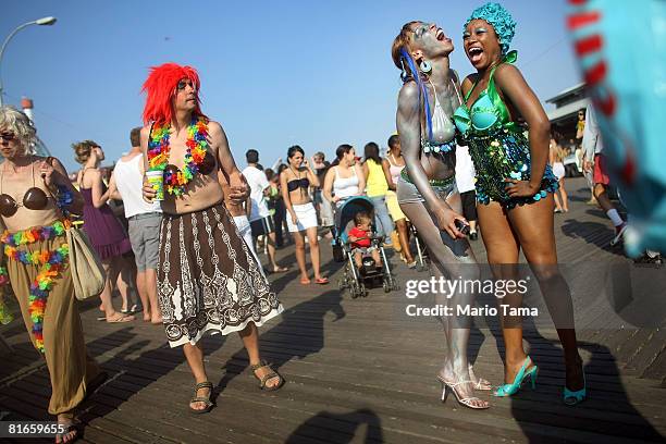 Revelers dance at the 25th annual Coney Island Mermaid Parade June 21, 2008 in the Brooklyn borough of New York City. One mermaid will launch a...