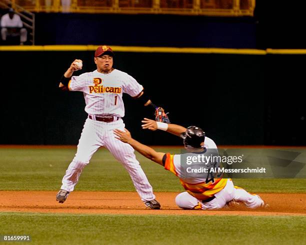 Designated hitter Carlos Lee of the Houston Astros breaks up a double play throw by infielder Akinori Iwamura of the Tampa Bay Rays June 21, 2008 at...