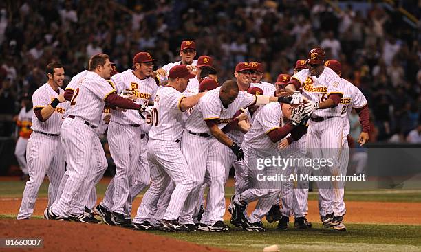 Teammates of pinch hitter Gabe Gross of the Tampa Bay Rays celebrate a game- winning double in the ninth inning against the Houston Astros June 21,...