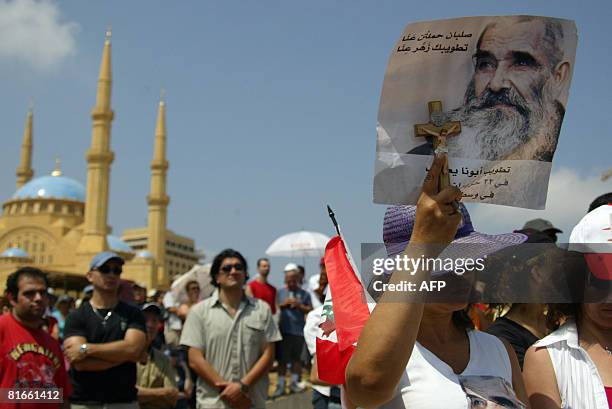 Lebanese woman holds a picture of Father James Ghazir Haddad during his beatification ceremony in central Beirut on June 22, 2008. The Vatican...