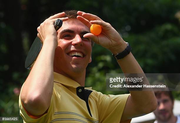 Philipp Lahm jokes during a table tennis match with his team mate Arne Friedrich at the German team squad hotel Il Giardino on June 21, 2008 in...