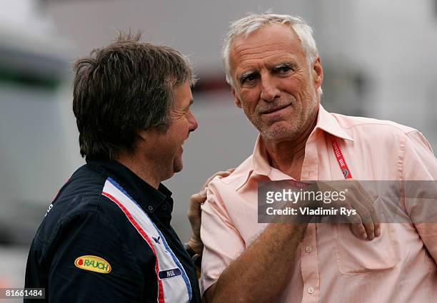 Red Bull Racing Chairman Dietrich Mateschitz speaks with one of the mechanics in the paddock prior to the French Formula One Grand Prix at the...