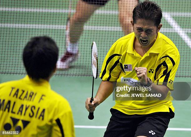 Zakry Abdul Latif and Fairuzizuan Mohammd Tazari of Malaysia celebrate defeating Tony Gunawan of the US and Candra Wijaya of Indonesia during their...