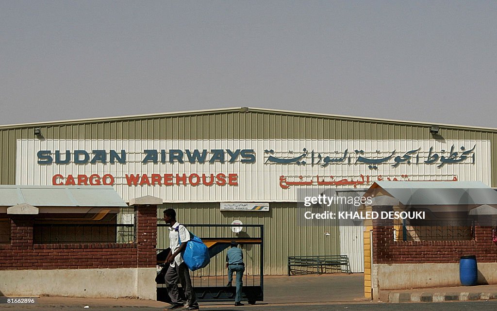 A Sudanese man walks past the cargo ware