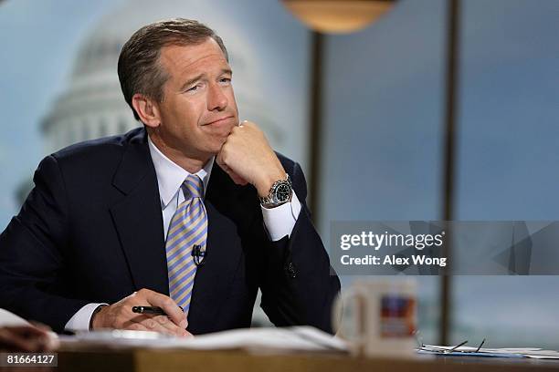 Moderator Brian Williams watches a video which pays tribute to late moderator Tim Russert during a taping of "Meet the Press" at the NBC studios June...