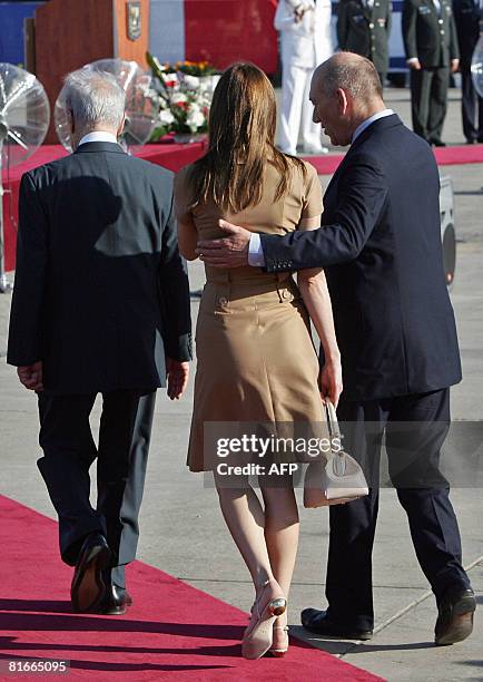 Israeli President Shimon Peres , French First Lady Carla Bruni-Sarkozy and Israeli Prime Minister Ehud Olmert walk during a welcoming ceremony for...