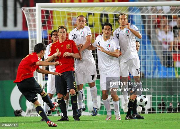Spanish forward David Villa takes a free kick as Italian midfielder Massimo Ambrosini , Italian forward Luca Toni , Italian midfielder Daniele De...