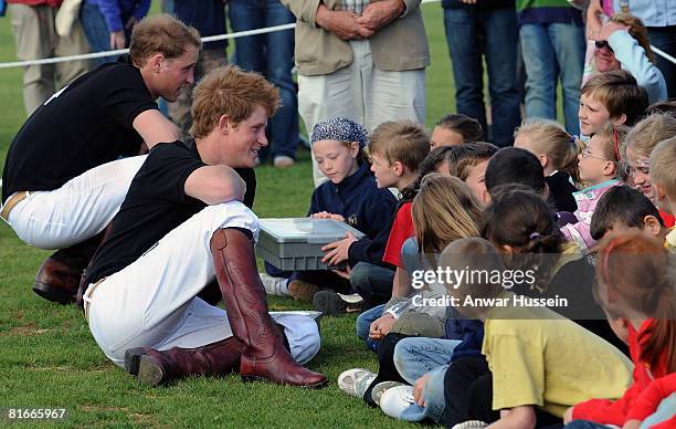 Prince Harry and Prince William chat to local children after competing in a charity polo match at the the Beaufort Polo Cub on June 22, 2008 in...