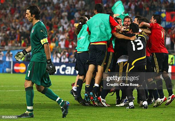 Gianluigi Buffon of Italy walks off dejected as Spanish players celebrate after Cesc Fabregas of Spain shoots and scores the winning penalty in the...