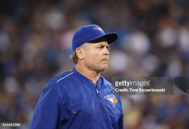 Manager John Gibbons of the Toronto Blue Jays returns to the dugout after making a pitching change in the eighth inning during MLB game action...