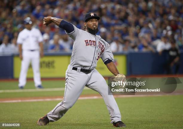 Dayan Diaz of the Houston Astros fields a soft gronder to the mound and throws out the baserunner in the sixth inning during MLB game action against...