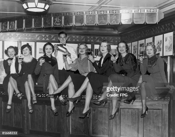 Group of young women at the bar on board the luxury liner SS Manhattan, off New York on the day Prohibition in the United States was repealed, 5th...