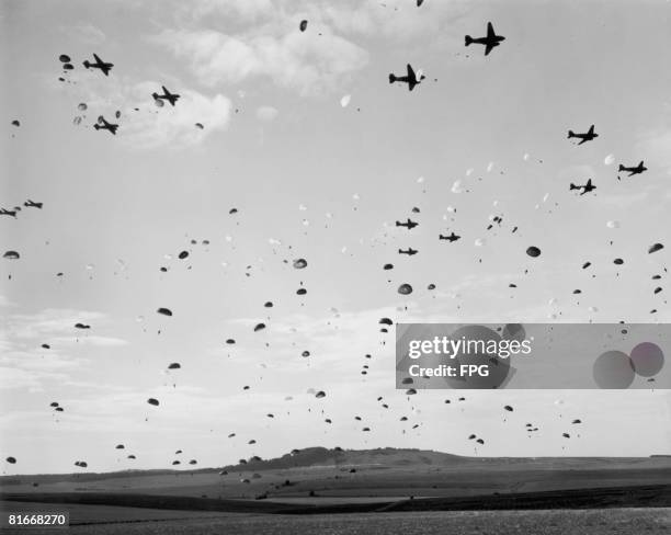 American paratroops make a mass jump during training in England, circa 1944.