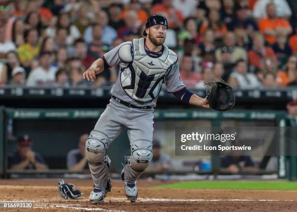 Minnesota Twins catcher Chris Gimenez looks for a throw to home plate during the MLB between the Minnesota Twins and Houston Astros on July 16, 2017...