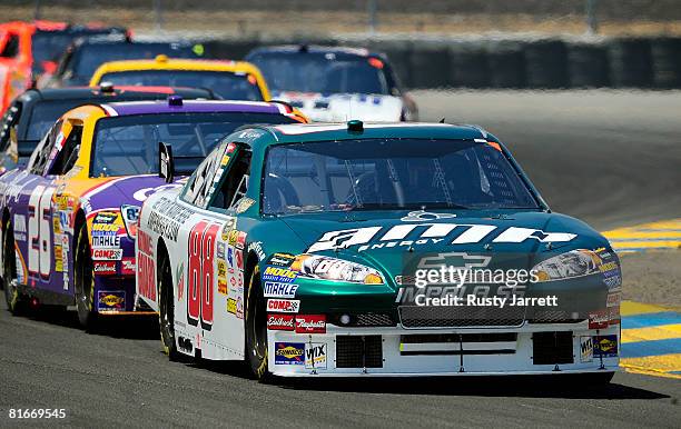 Dale Earnhardt Jr., driver of the AMP/National Guard Chevrolet, leads Jamie McMurray, driver of the Crown Royal Ford, during the NASCAR Sprint Cup...