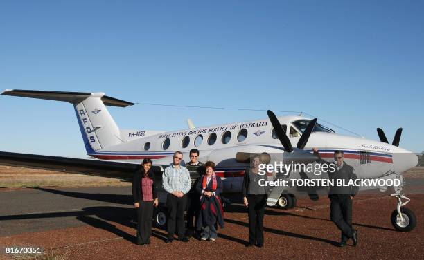 By Lawrence Barlett Captain Graham Sorrenson stands beside the Royal Flying Doctor Service's Beechcraft SuperKingair with Dr. Michael Hennessy and...